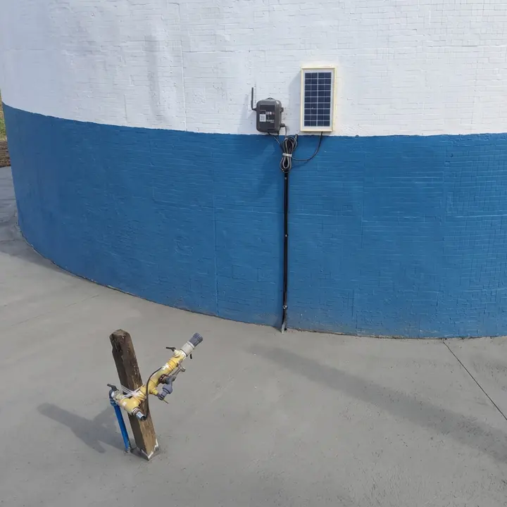 Node Connect with a small solar panel on the wall of a tank.